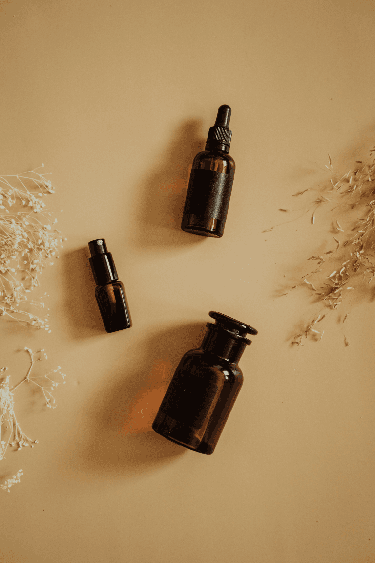 Amber essential oil bottles with dried botanicals